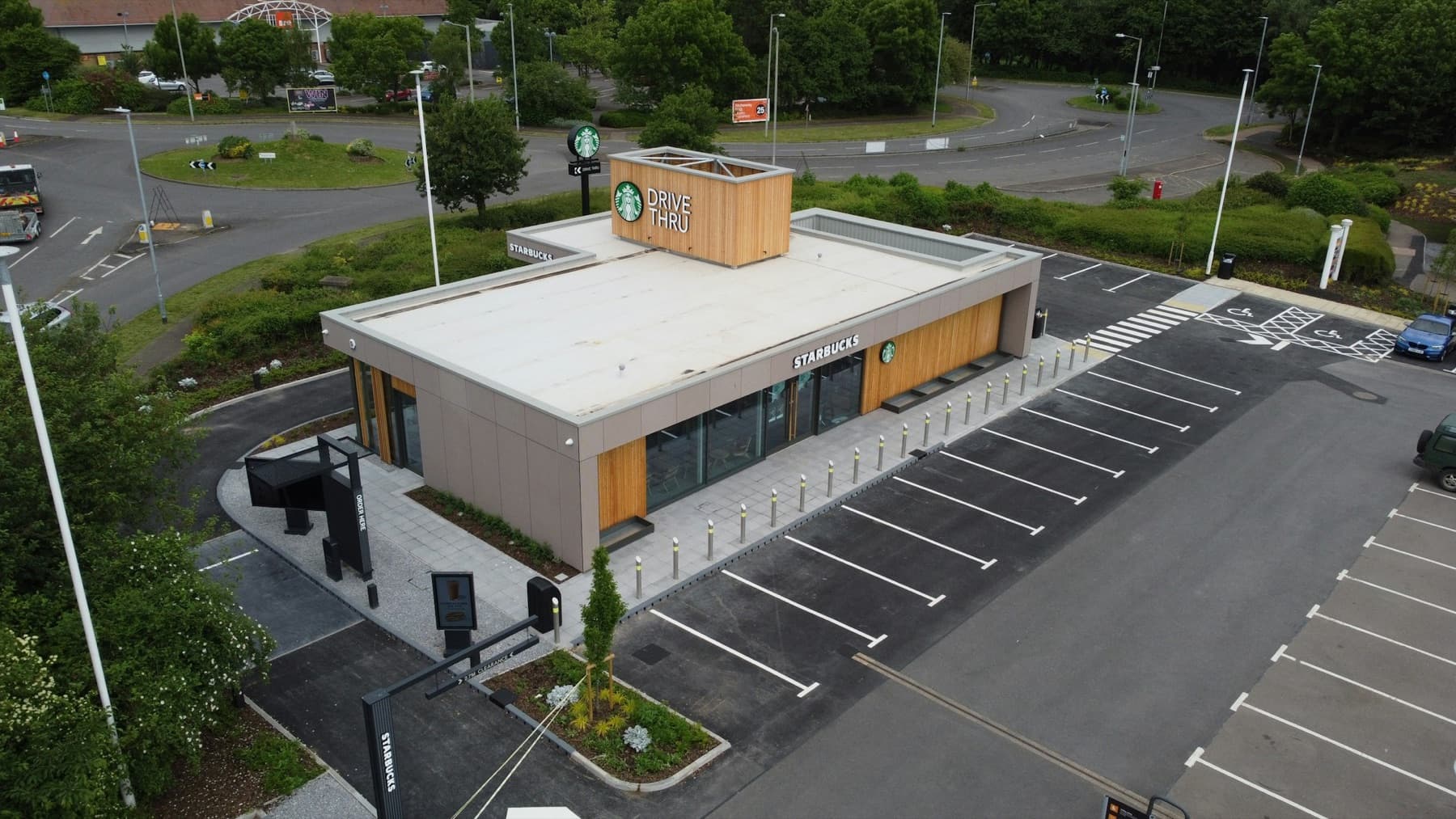 Aerial view of a Starbucks drive-thru pad with its parking lot