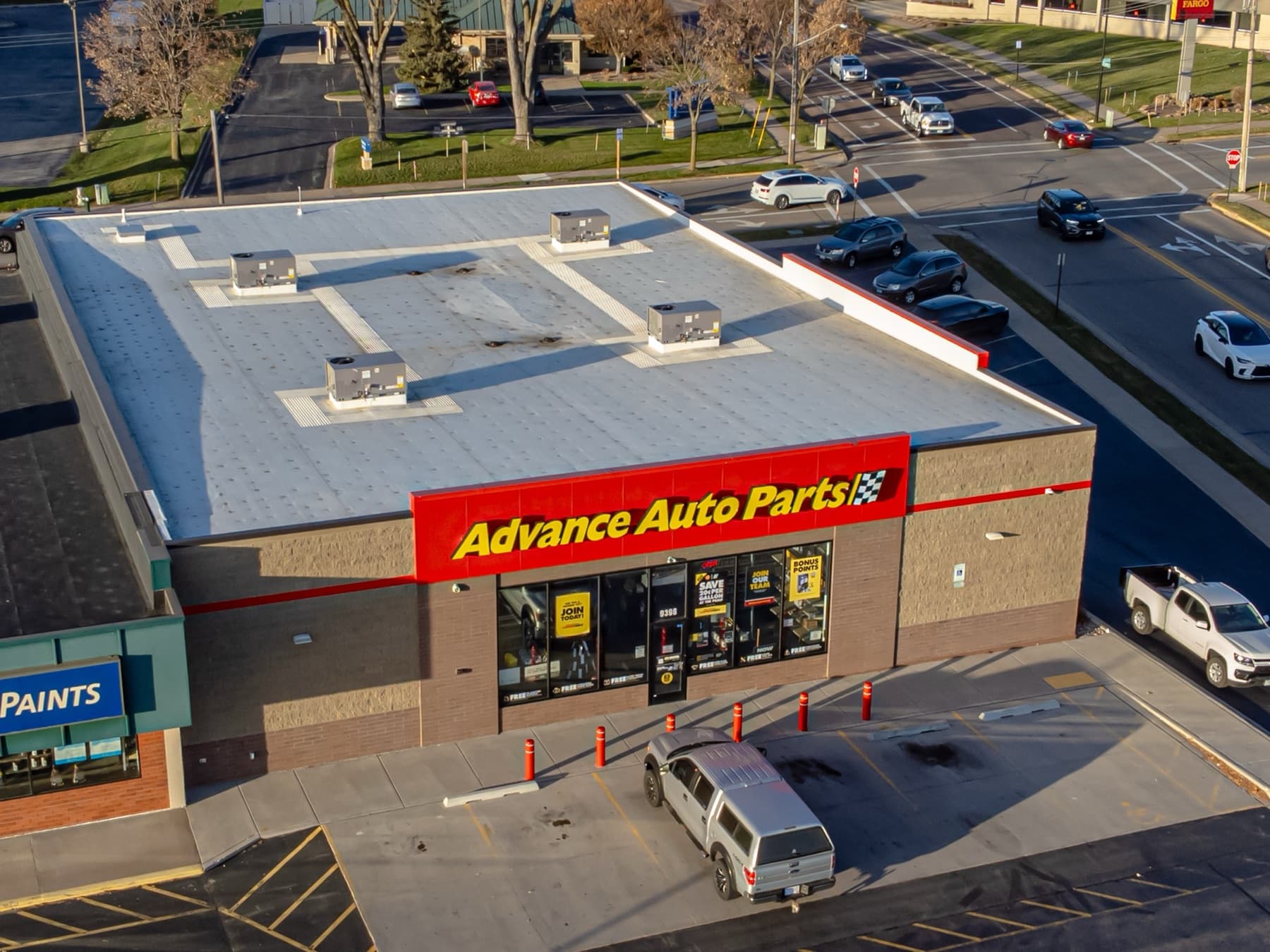 Aerial view of a single-tenant auto parts store showing its flat roof and rooftop HVAC units