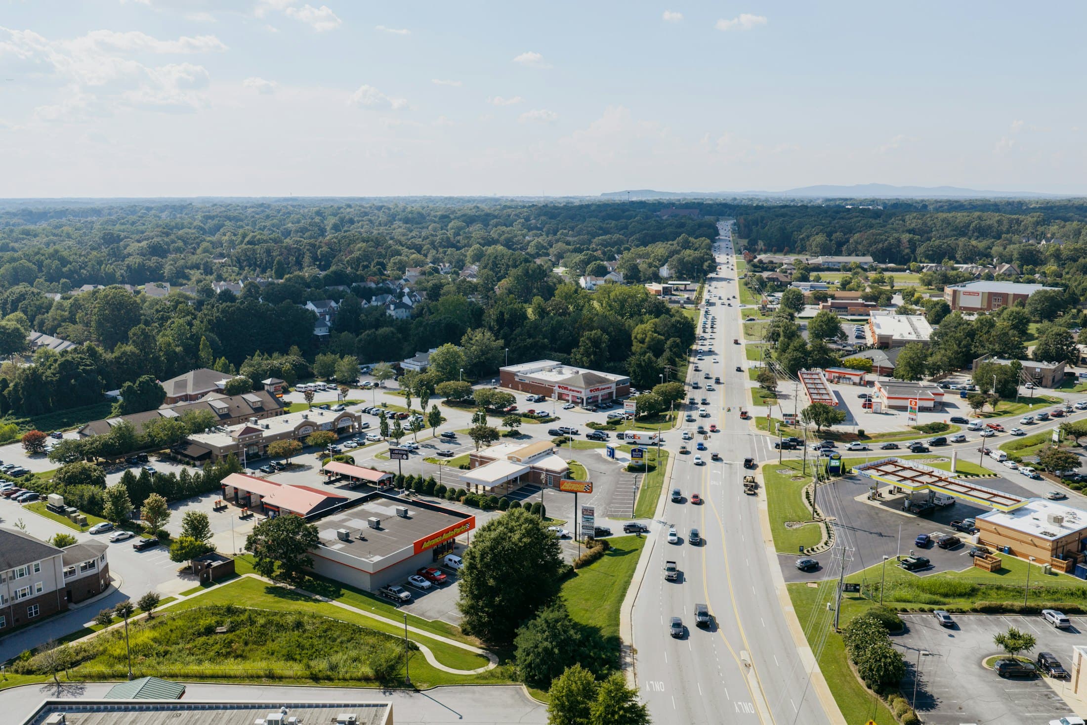 Aerial view of a commercial corridor lined with single-tenant retail buildings
